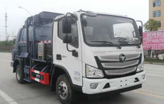 Barreled garbage collection truck